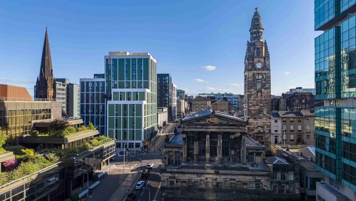 Glasgow city centre skyline at street level, with St Vincent Street spire and modern glass towers